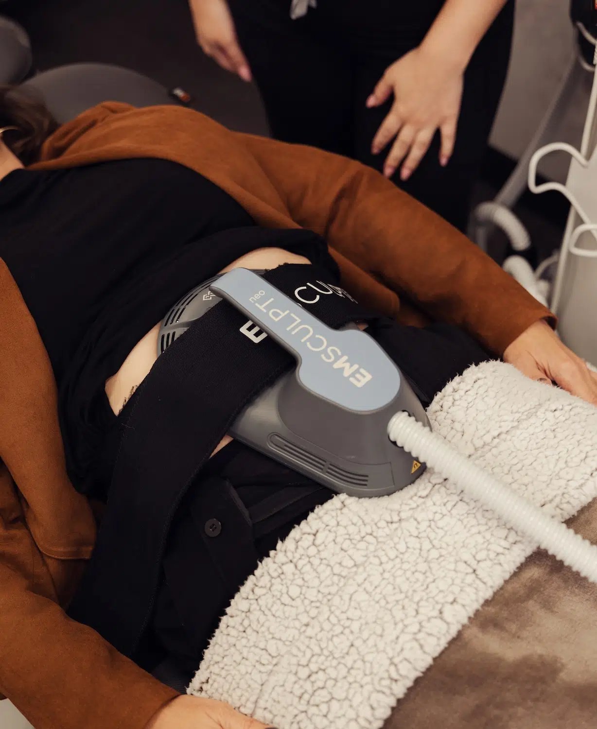 woman receiving emsculpt treatment at bcrn woman receiving emsculpt treatment at bcrn